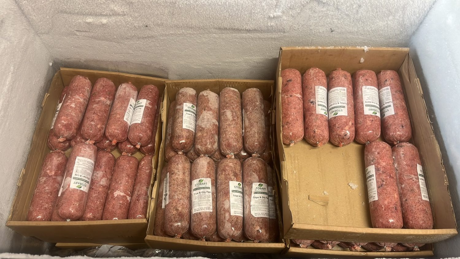 Boxes of Stobart raw dog food in a range of flavours